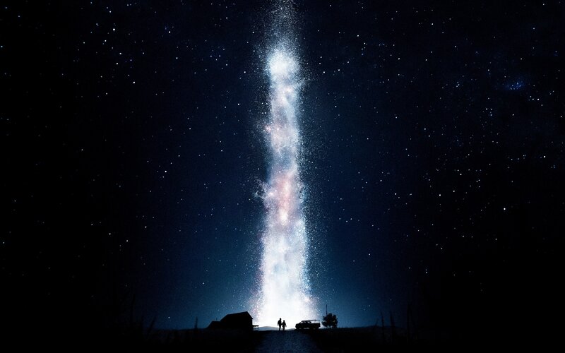 Silhouetted Figures under Galaxy