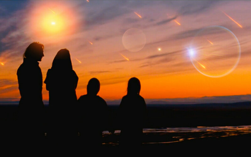 Silhouetted Figures Watching Meteor Shower