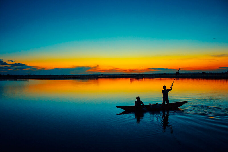 Silhouetted Fishermen in Boat — Blue