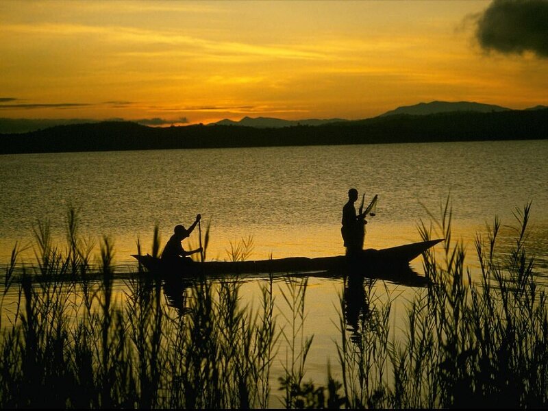 Silhouetted Fishermen in Canoe