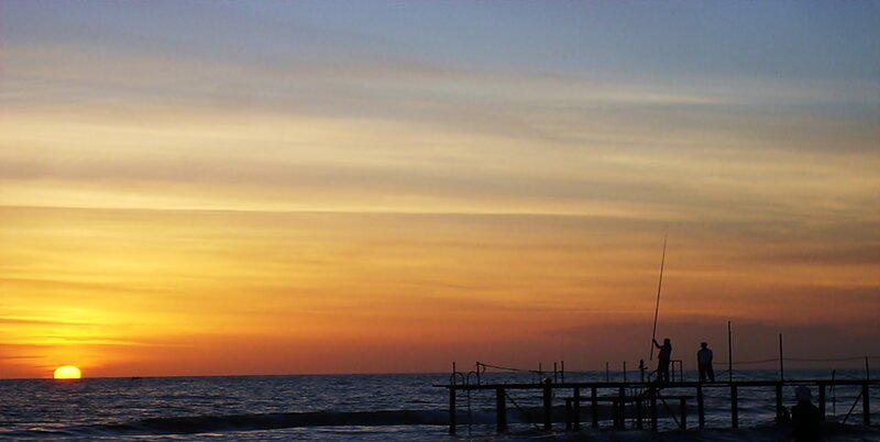 Silhouetted Fishermen on Pier — Orange, Serene