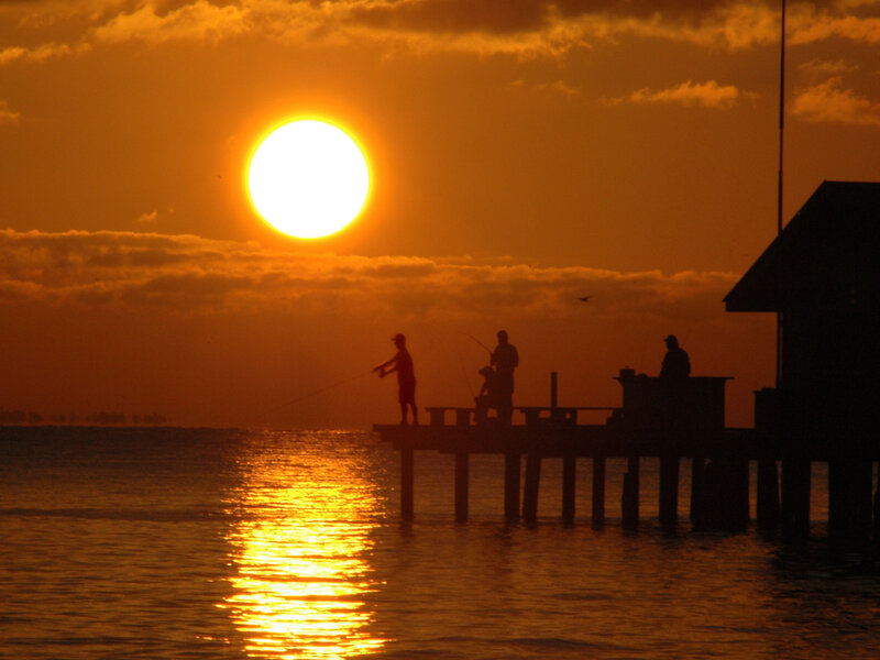 Silhouetted Fishermen on Pier — Orange