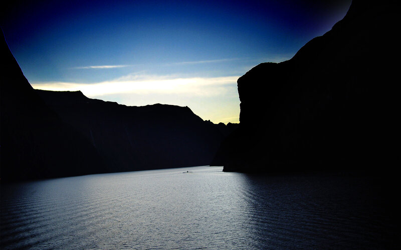 Silhouetted fjord at dusk
