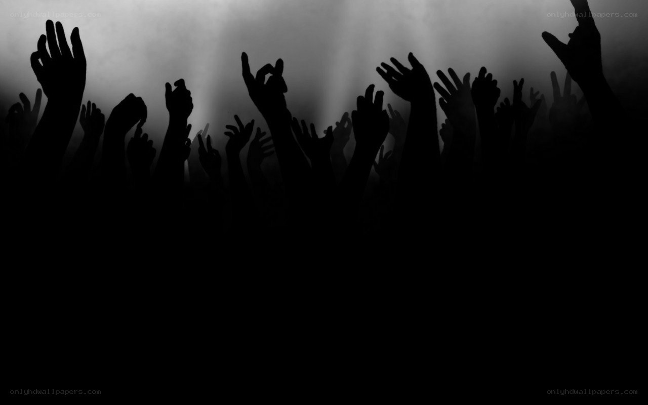 silhouetted hands at concert