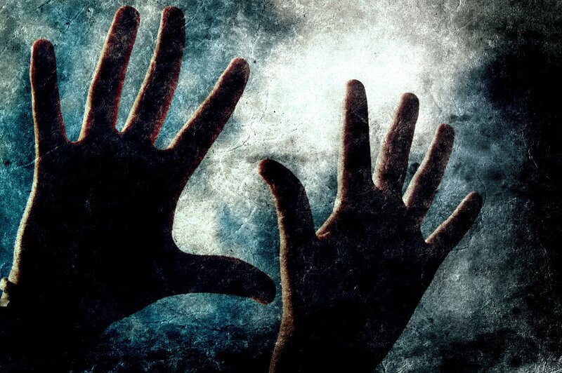 Silhouetted Hands on Wall