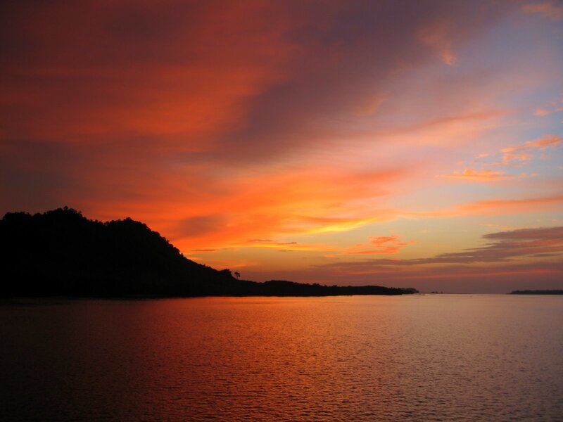 Silhouetted Hill at Sunset — Orange, Dramatic, Photograph, Sky, Water