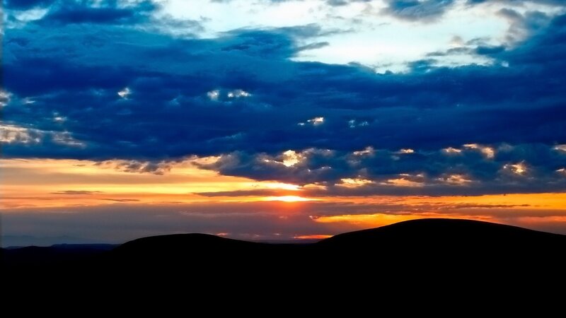 Silhouetted Hills at Sunset — Blue, Dramatic, Photograph, Clouds, Sun