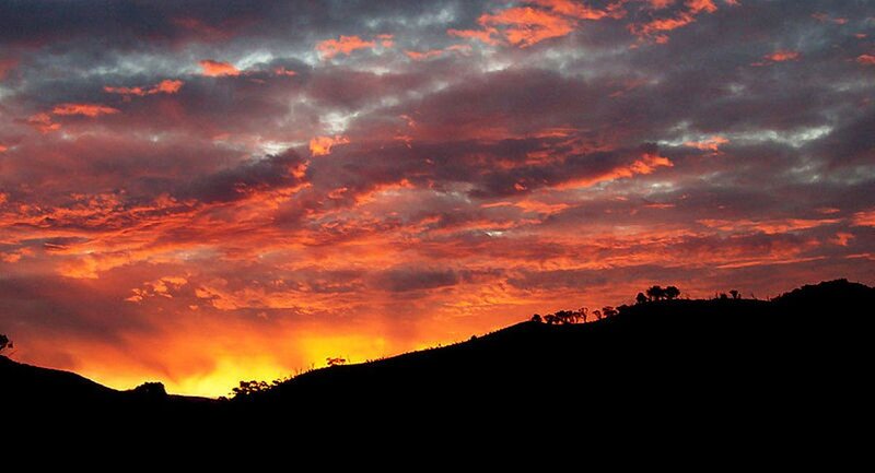 Silhouetted Hills at Sunset — Orange, Dramatic, Photograph, Clouds