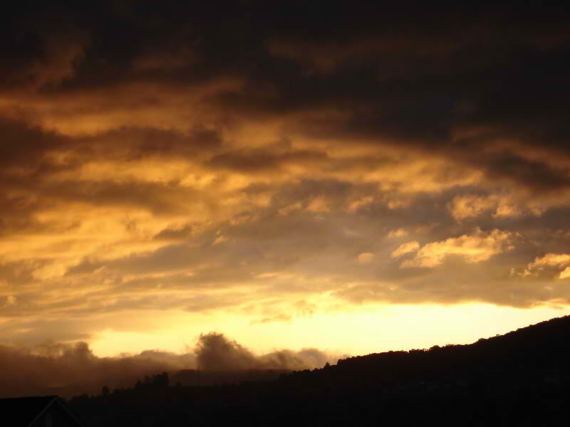 Silhouetted Hills at Sunset — Orange, Dramatic, Photograph