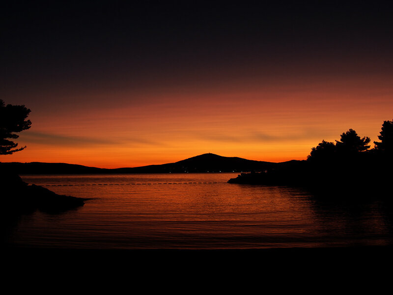 Silhouetted Hills at Sunset — Orange, Serene