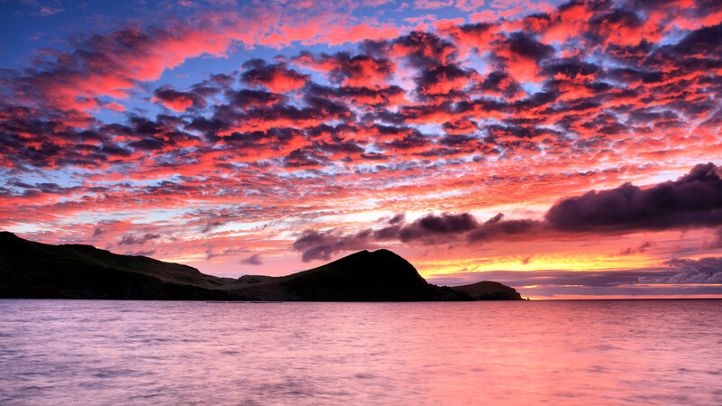 Silhouetted Hills at Sunset — Red, Dramatic, Photograph