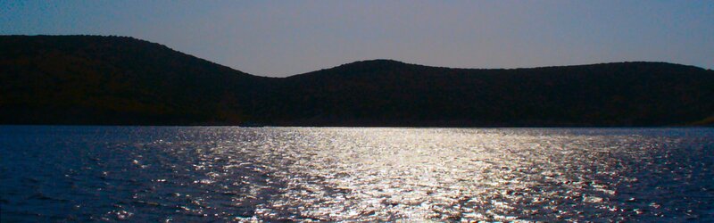 Silhouetted Hills over Water — Blue
