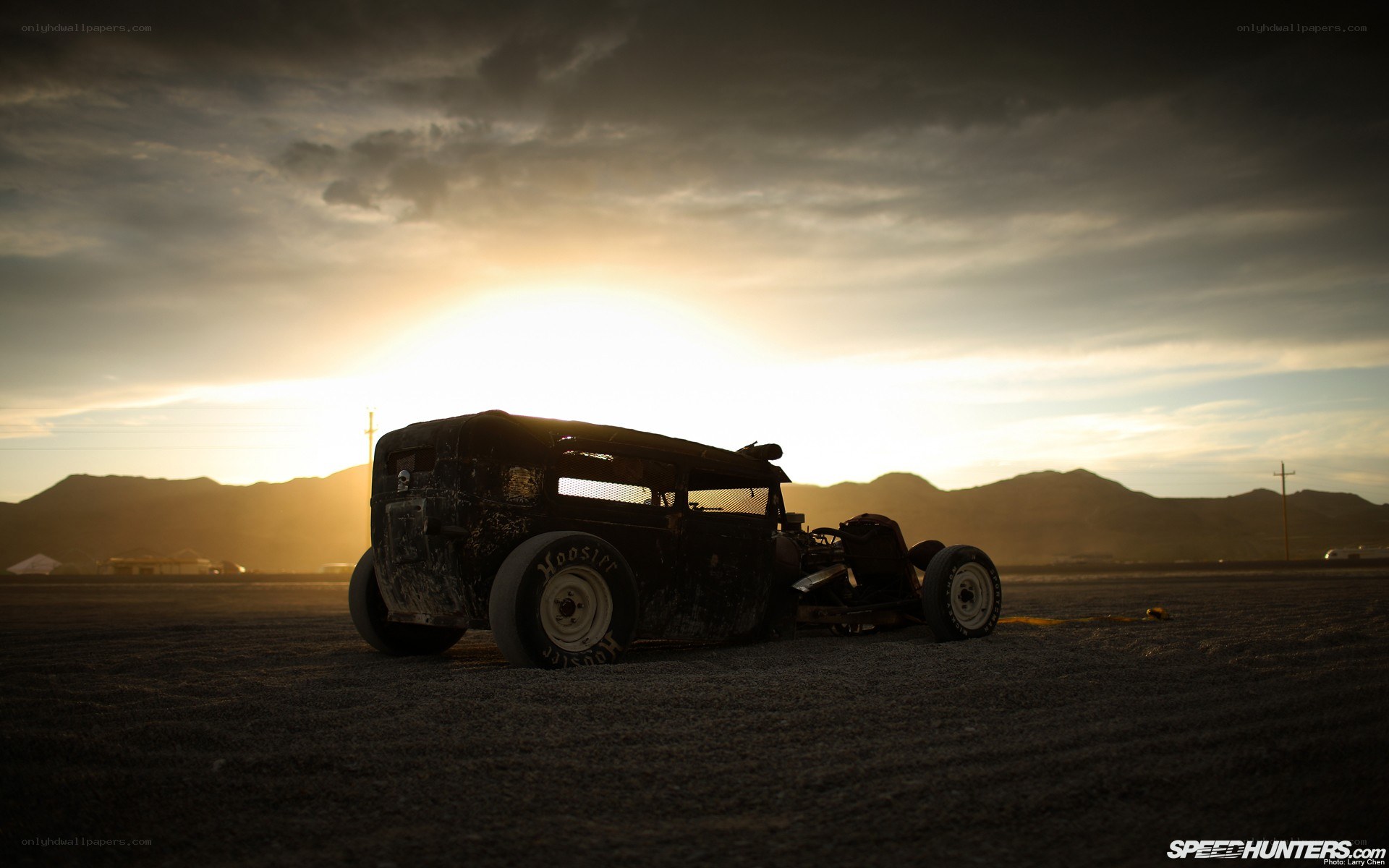 silhouetted hot rod at sunset