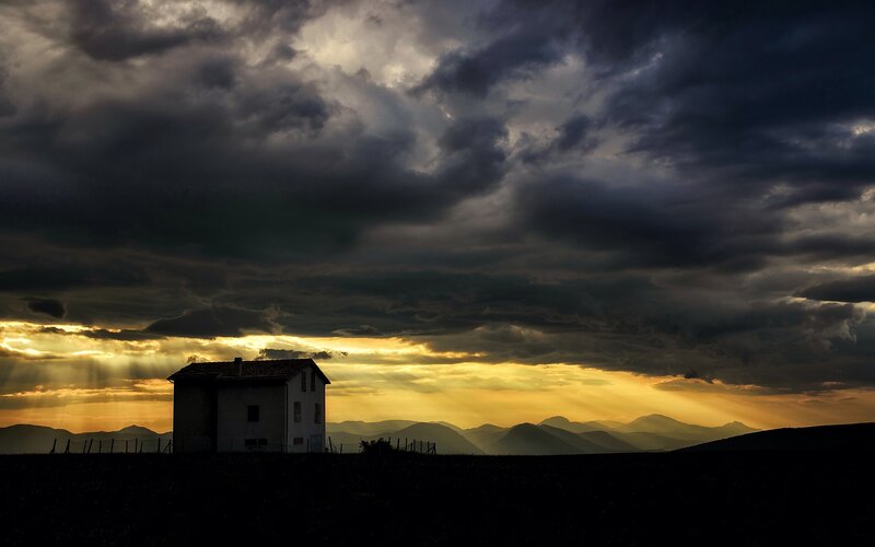 Silhouetted House on Hill
