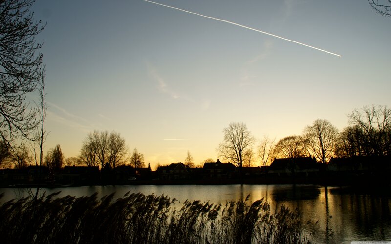Silhouetted Houses by Lake