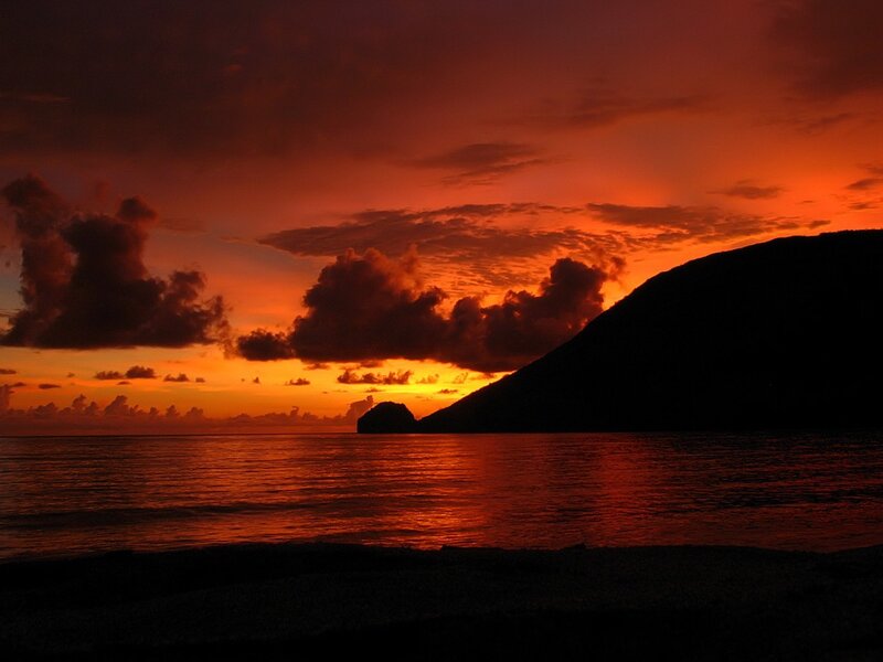 Silhouetted Island at Sunset — Orange, Dramatic, Photograph, Ocean, Clouds