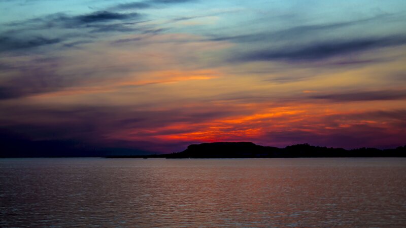 Silhouetted Island at Sunset — Orange, Dramatic, Photograph, Sky