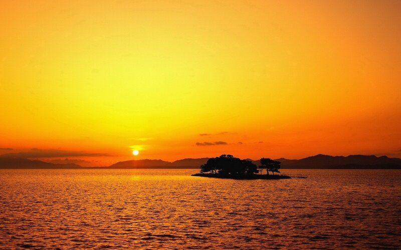 Silhouetted Island at Sunset — Orange, Serene