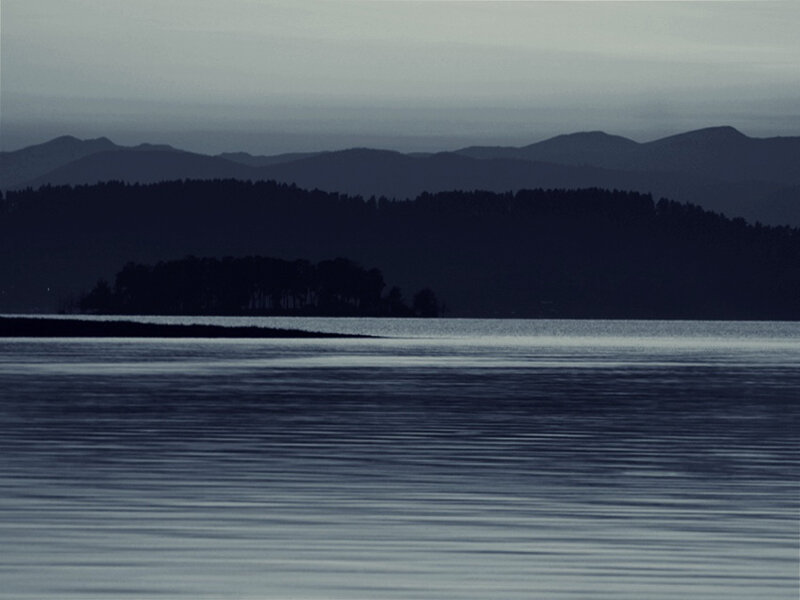Silhouetted Island in Water — Blue