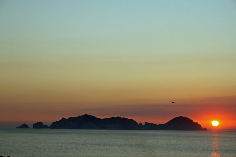 Silhouetted Islands at Sunset — Orange, Serene