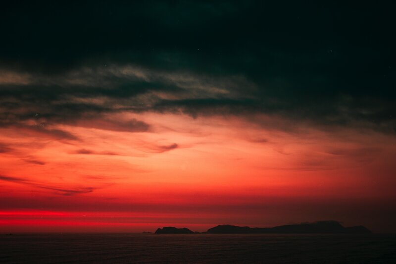 Silhouetted Islands at Sunset — Red, Dramatic