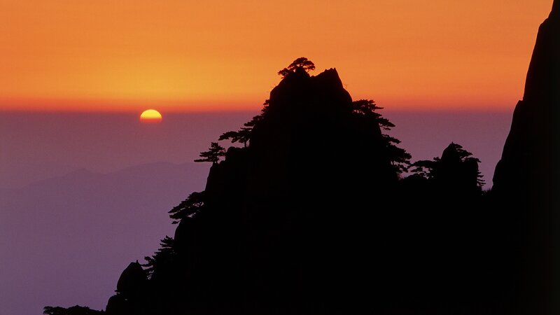 Silhouetted Mountain Peak — Orange, Serene, Sunset