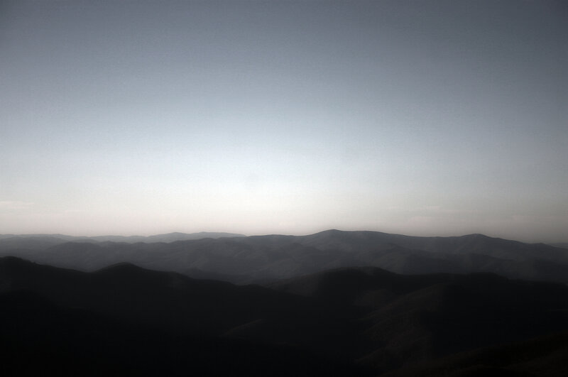 Silhouetted mountain ranges at dawn