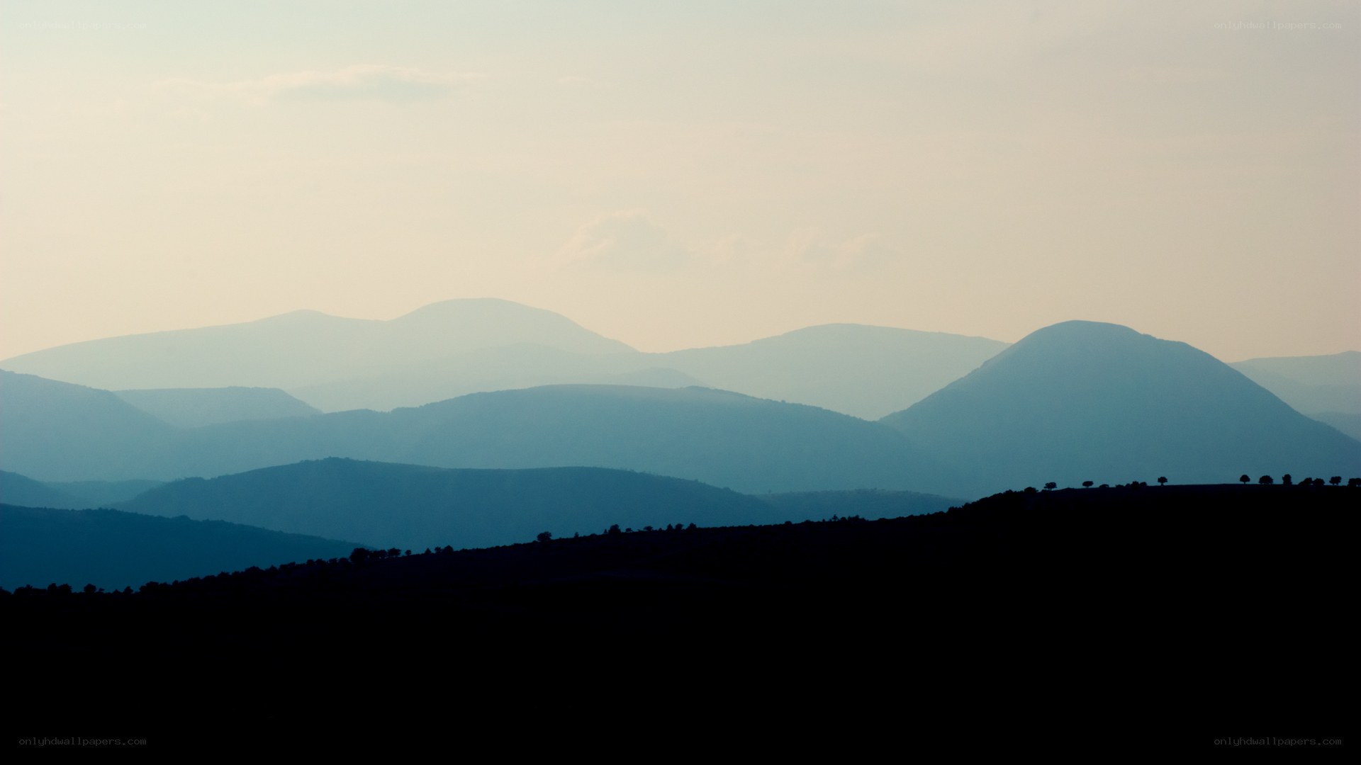 Silhouetted mountain ranges at dusk