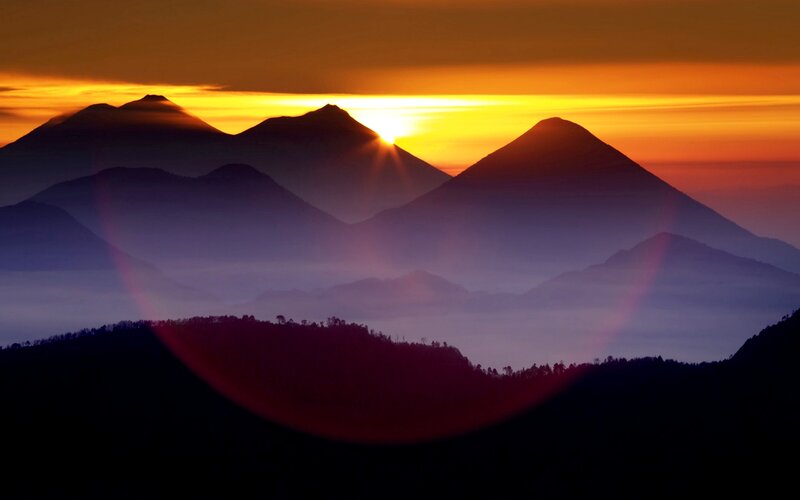 Silhouetted Mountains at Sunrise