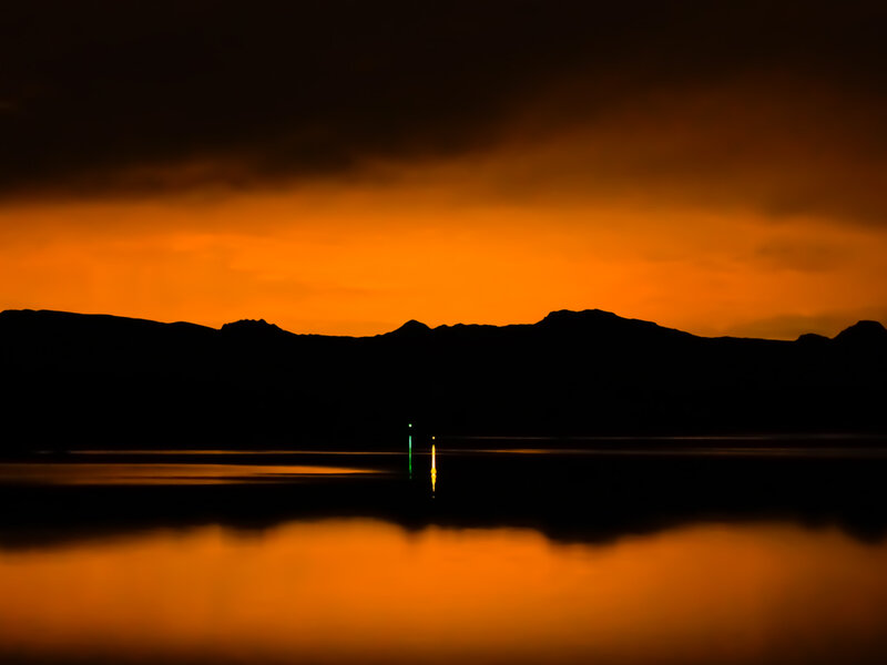 Silhouetted Mountains at Sunset — Orange, Dramatic, Photograph, Water