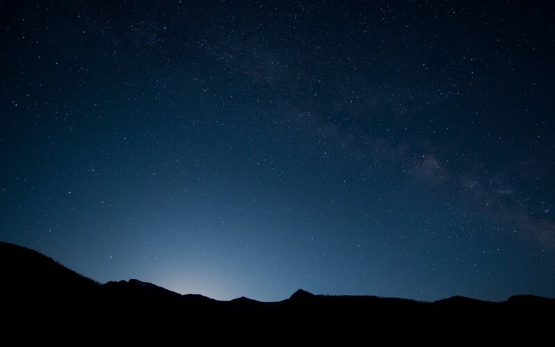 Silhouetted Mountains under Stars — Night