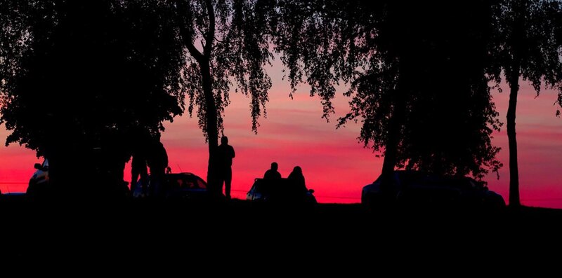Silhouetted People at Sunset — Red