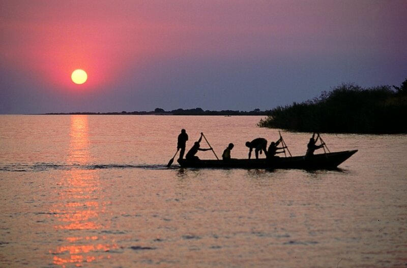 Silhouetted People in Boat
