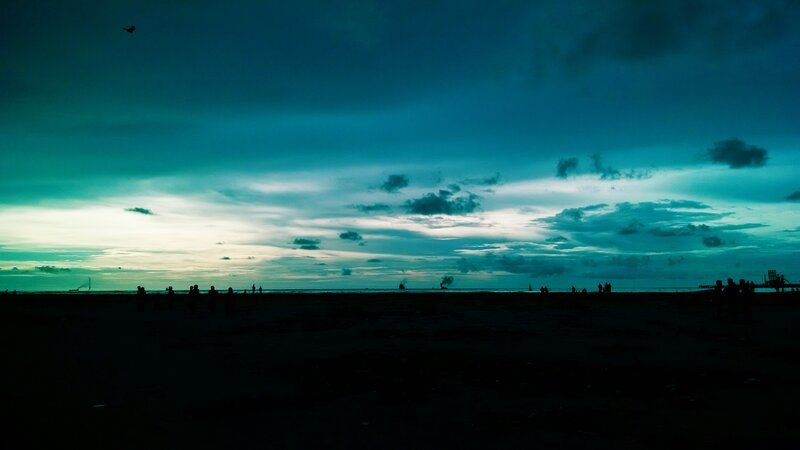 Silhouetted People on Beach — Blue, Dramatic, Sunset, Photograph, Sky