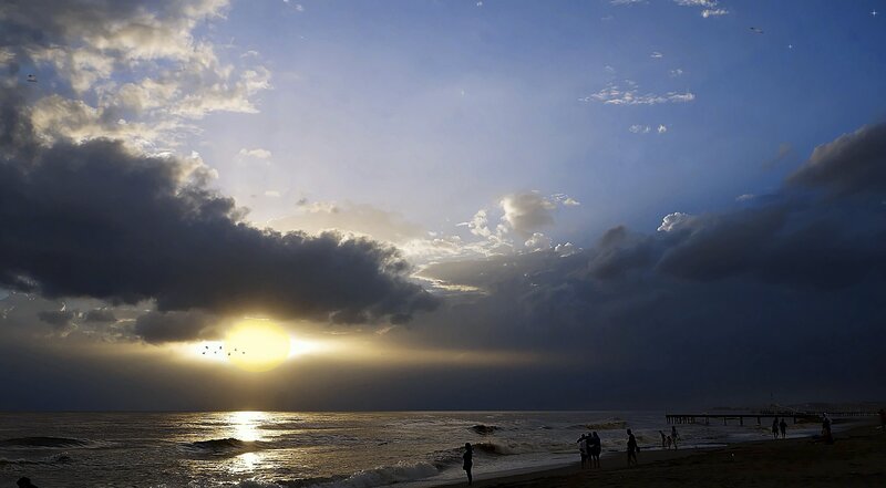 Silhouetted People on Beach — Blue, Dramatic, Sunset, Photograph, Sun, Clouds