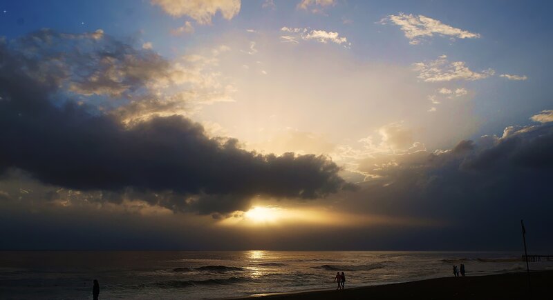 Silhouetted People on Beach — Blue, Dramatic, Sunset, Photograph, Sun