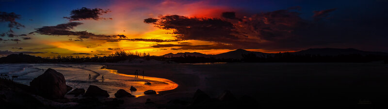 Silhouetted People on Beach — Orange, Dramatic, Sunset, Photograph, Mountains, Sky