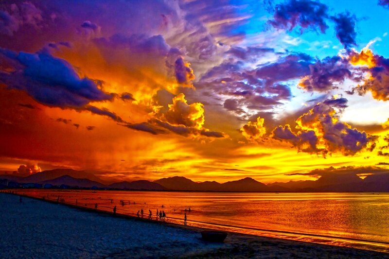 Silhouetted People on Beach — Orange, Dramatic, Sunset, Photograph, Mountains