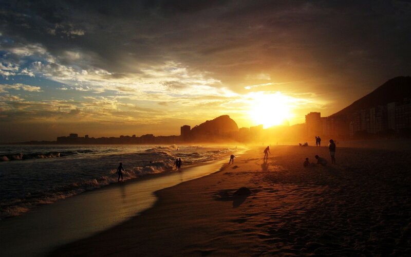 Silhouetted People on Beach — Orange, Dramatic, Sunset, Photograph, Ocean