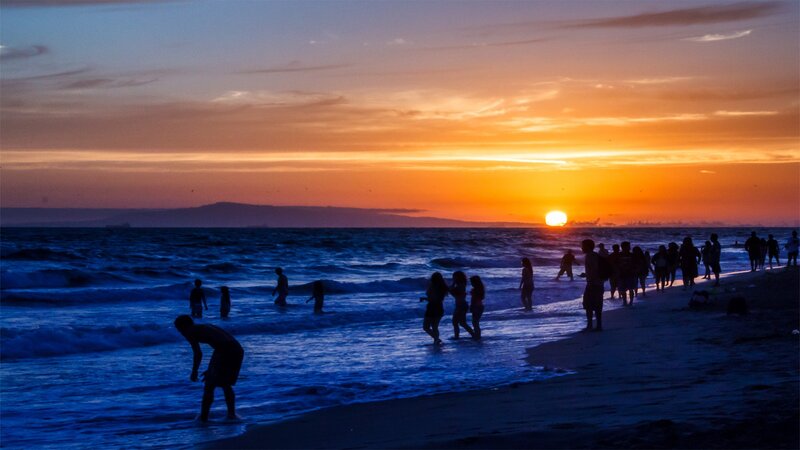 Silhouetted People on Beach — Orange, Dramatic, Sunset, Photograph, Ocean, Waves