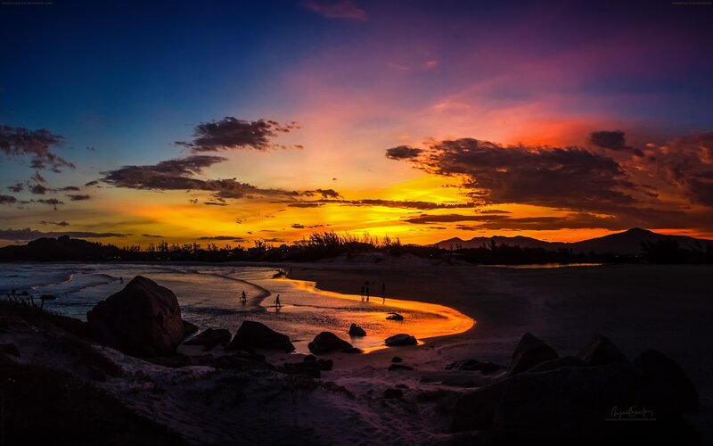 Silhouetted People on Beach — Orange, Dramatic, Sunset, Photograph, Rocks