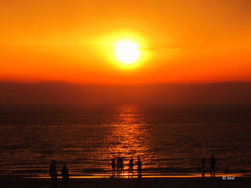 Silhouetted People on Beach — Orange, Dramatic, Sunset, Photograph, Sun