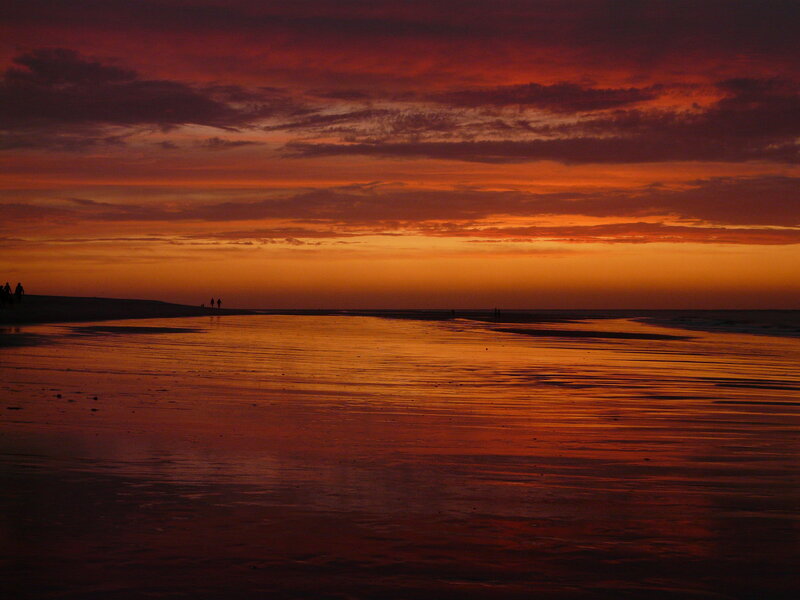 Silhouetted People on Beach — Orange, Dramatic