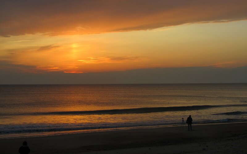 Silhouetted People on Beach — Orange, Serene, Sunset, Photograph, Ocean, Sky, Tripod