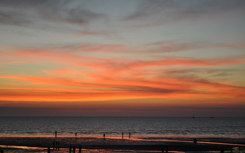 Silhouetted People on Beach — Orange, Serene, Sunset, Photograph, Sky