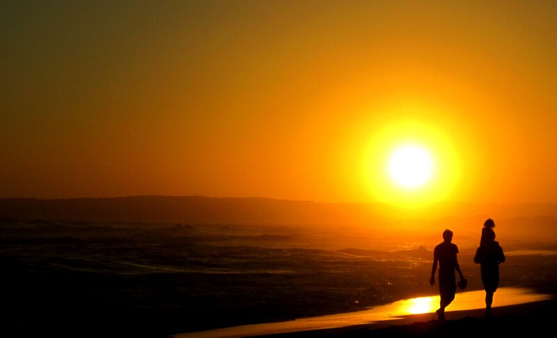 Silhouetted People on Beach — Orange, Serene, Sunset, Photograph, Sun, Ocean
