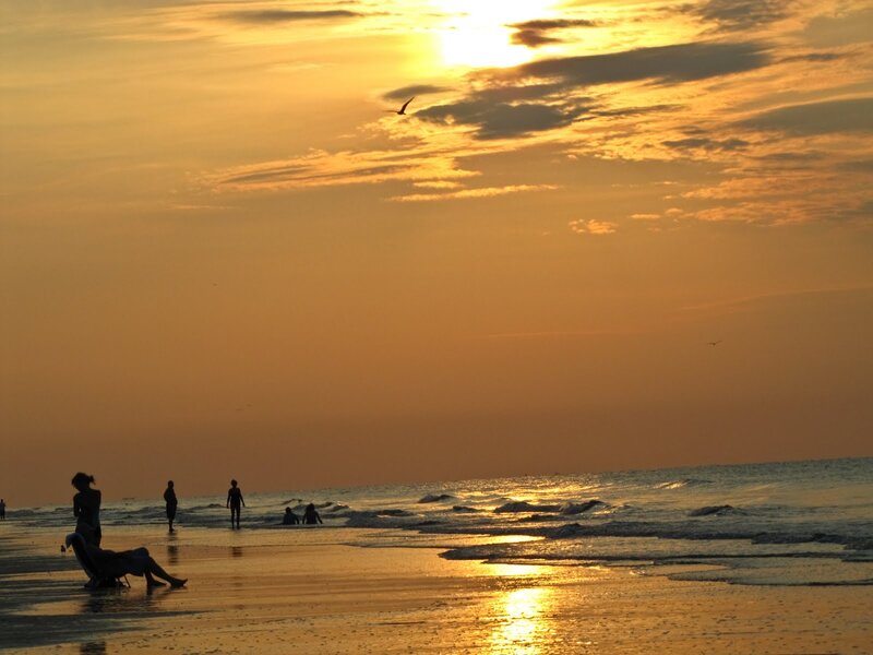 Silhouetted People on Beach — Orange, Serene, Sunset