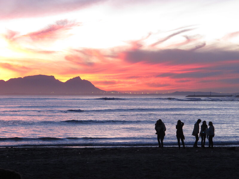 Silhouetted People on Beach — Pink