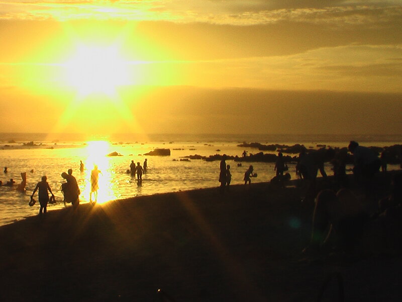 Silhouetted People on Beach — Yellow, Dramatic, Sunset, Photograph, Sun, Ocean