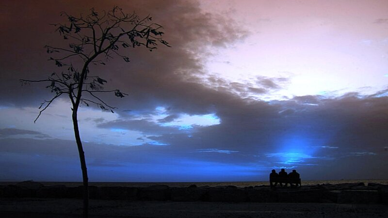 Silhouetted People on Bench